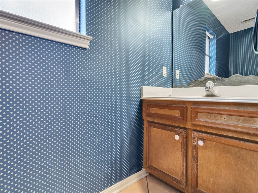 12306 Knobcrest Drive Houston, TX 77070 - Photo 18 of 33 a bathroom with a sink and a mirror