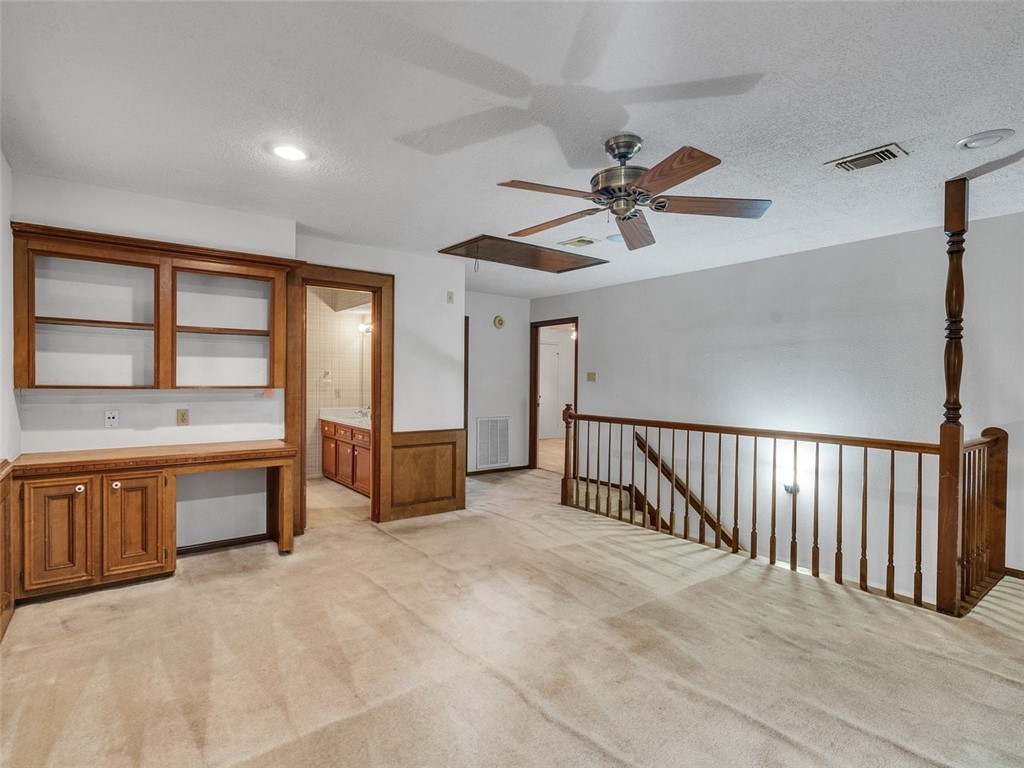 12306 Knobcrest Drive Houston, TX 77070 - Photo 23 of 33 a spacious bedroom with a large bed and a chandelier