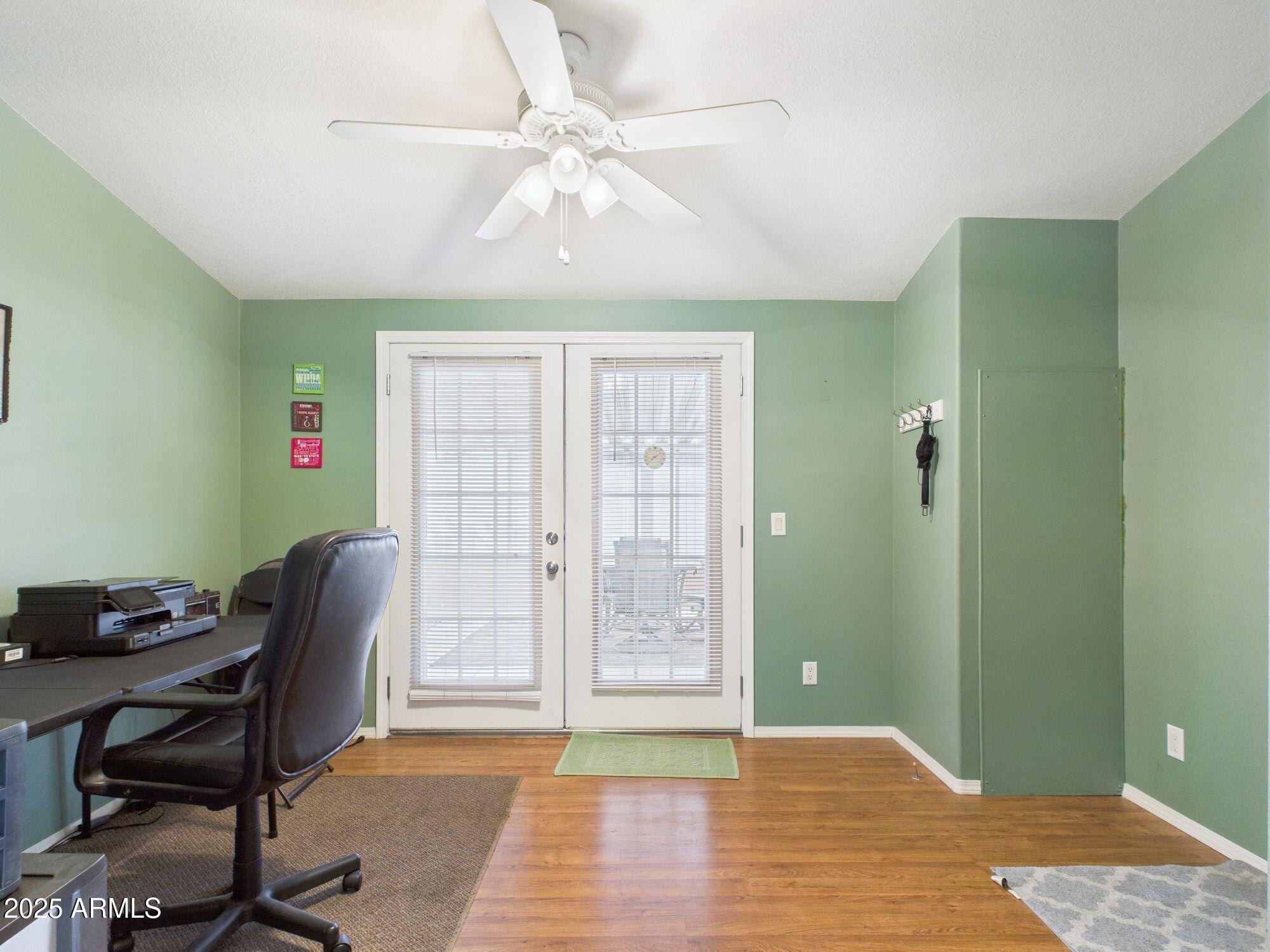 3104 East Broadway Road, Unit 230 Mesa, AZ 85204 - Photo 14 of 24 a workspace with wooden floor and a chandelier fan