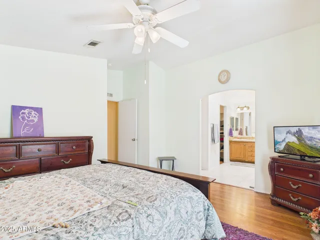 a bedroom with a bed and wooden floor