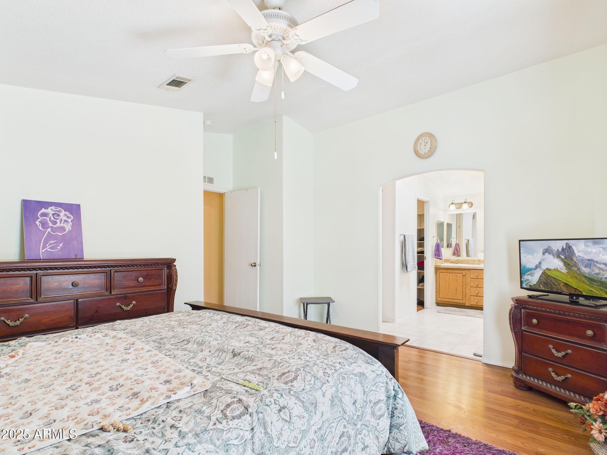 3104 East Broadway Road, Unit 230 Mesa, AZ 85204 - Photo 16 of 24 a bedroom with a bed and wooden floor