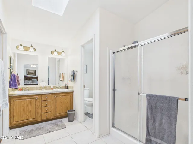 a large bathroom with a double vanity sink a mirror and a bathtub