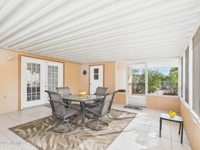 a view of a dining room with furniture large windows and wooden floor
