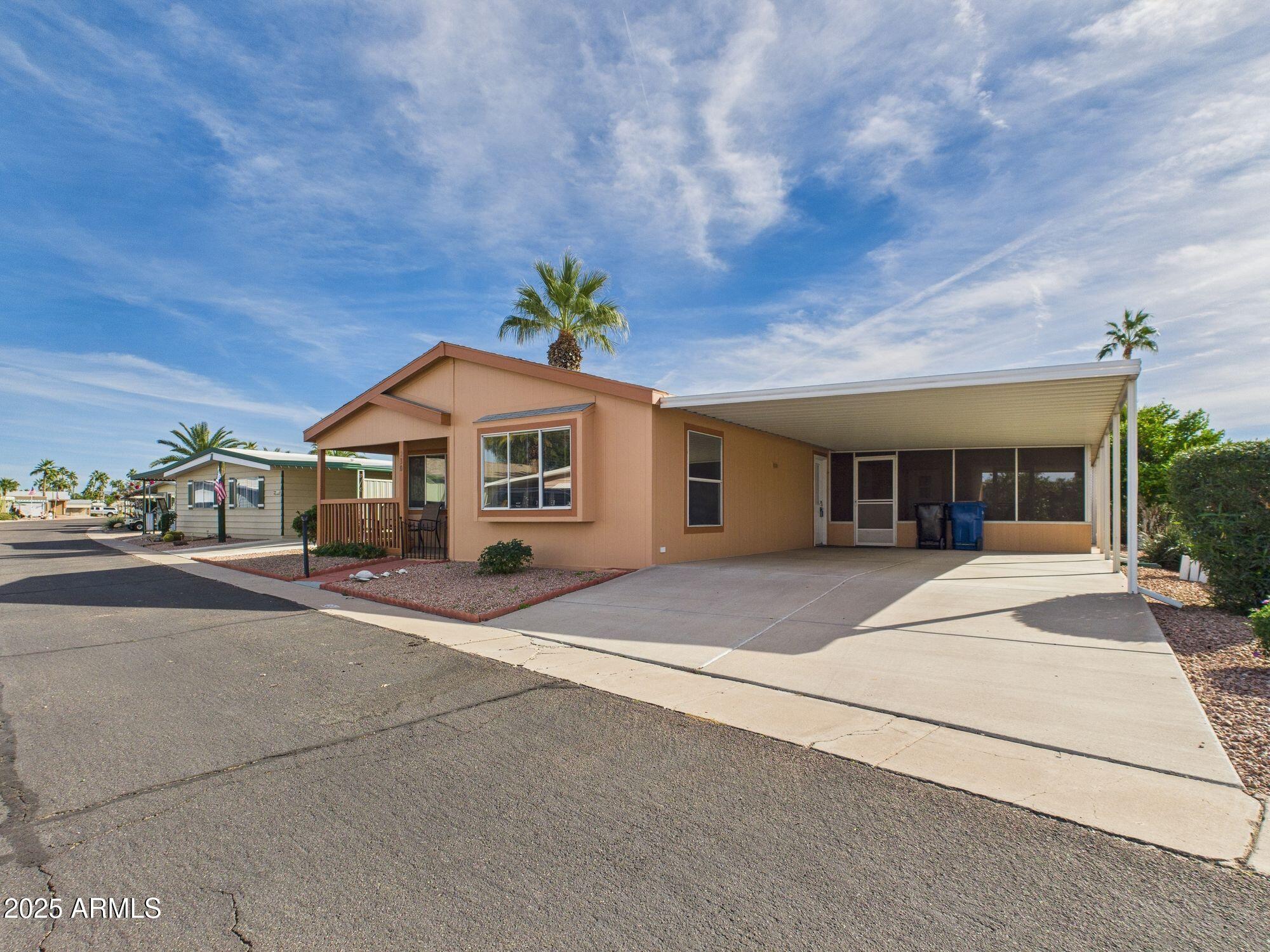 3104 East Broadway Road, Unit 230 Mesa, AZ 85204 - Photo 3 of 24 a front view of a house with a yard and garage