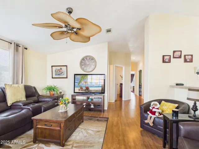 a living room with furniture and wooden floor