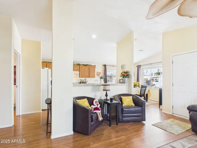 a living room with furniture and a dining table with kitchen view