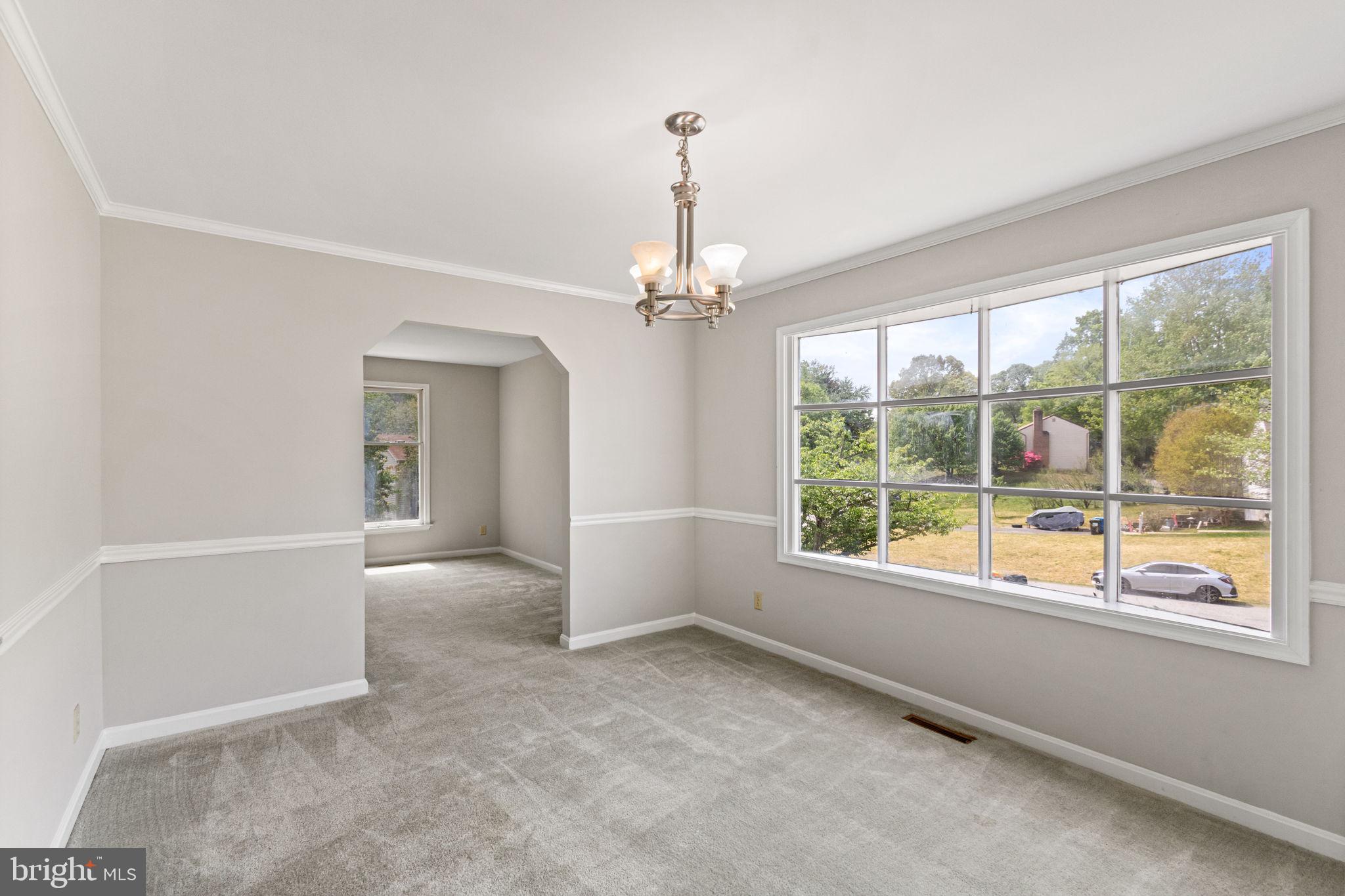 127 Oaklawn Road Stafford, VA 22554 - Photo 13 of 54 an empty room with windows and chandelier