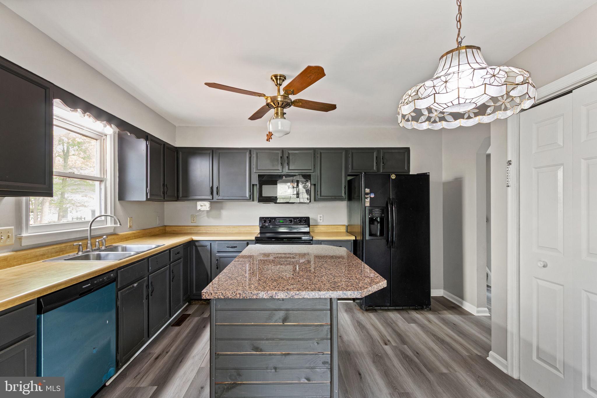 127 Oaklawn Road Stafford, VA 22554 - Photo 15 of 54 a kitchen with stainless steel appliances granite countertop a sink dishwasher stove and refrigerator with wooden floor