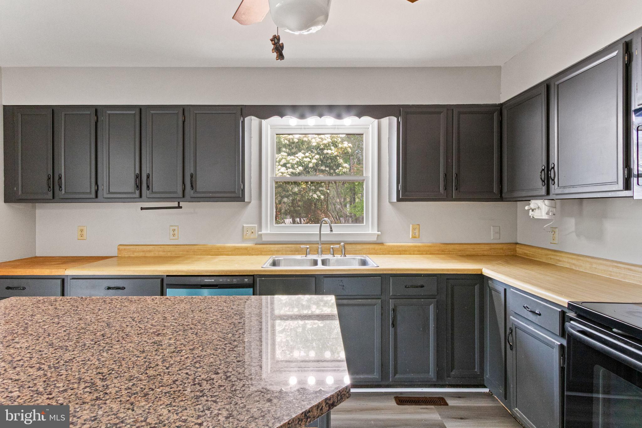 127 Oaklawn Road Stafford, VA 22554 - Photo 16 of 54 a kitchen with granite countertop a sink window and cabinets