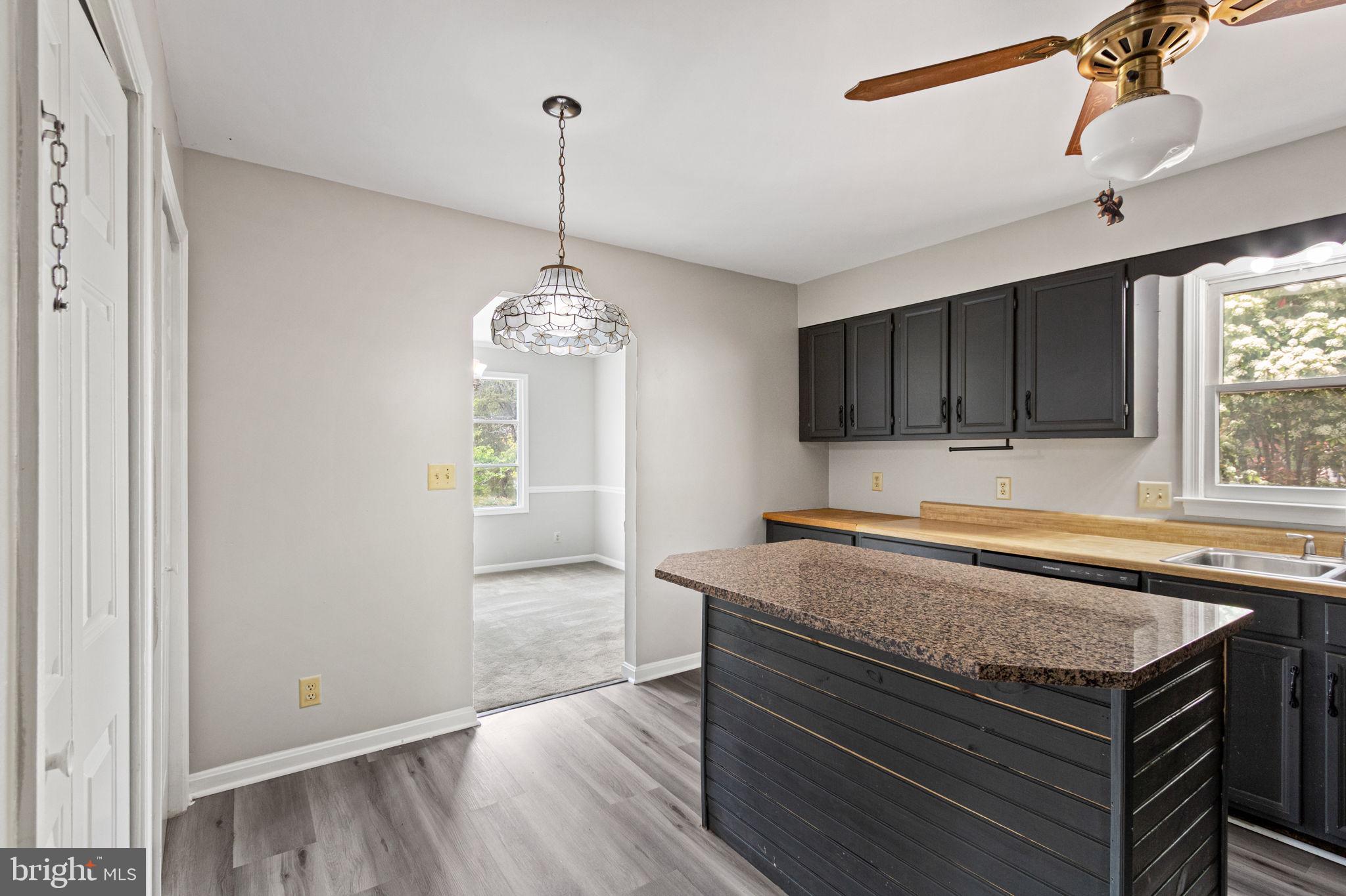 127 Oaklawn Road Stafford, VA 22554 - Photo 17 of 54 a view of a kitchen island a sink wooden floor and a window