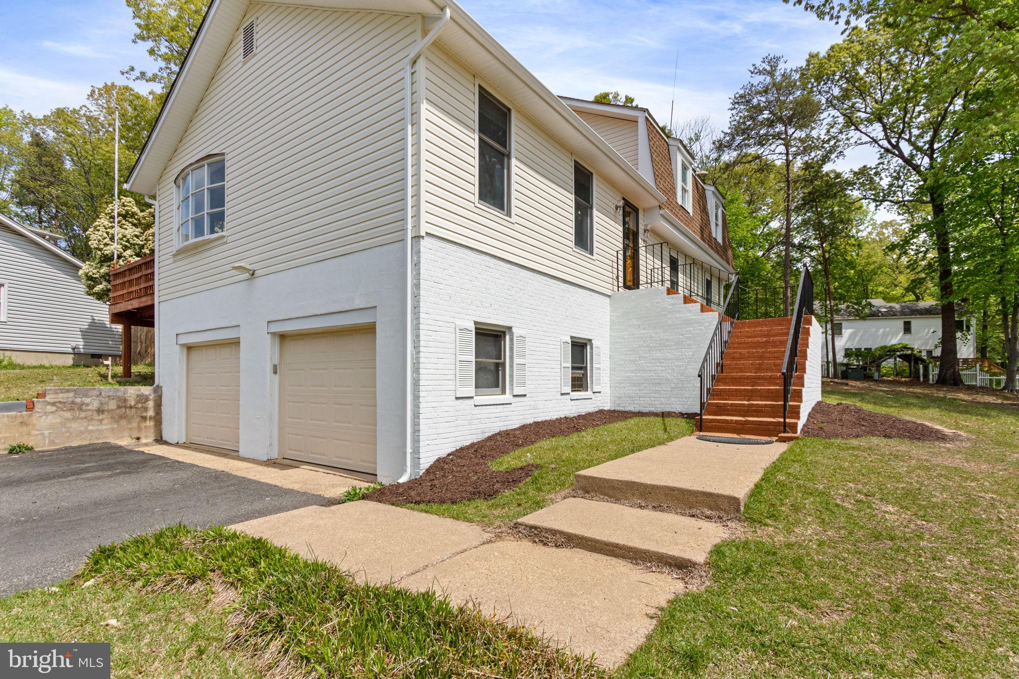 127 Oaklawn Road Stafford, VA 22554 - Photo 4 of 54 a front view of a house with a yard and garage