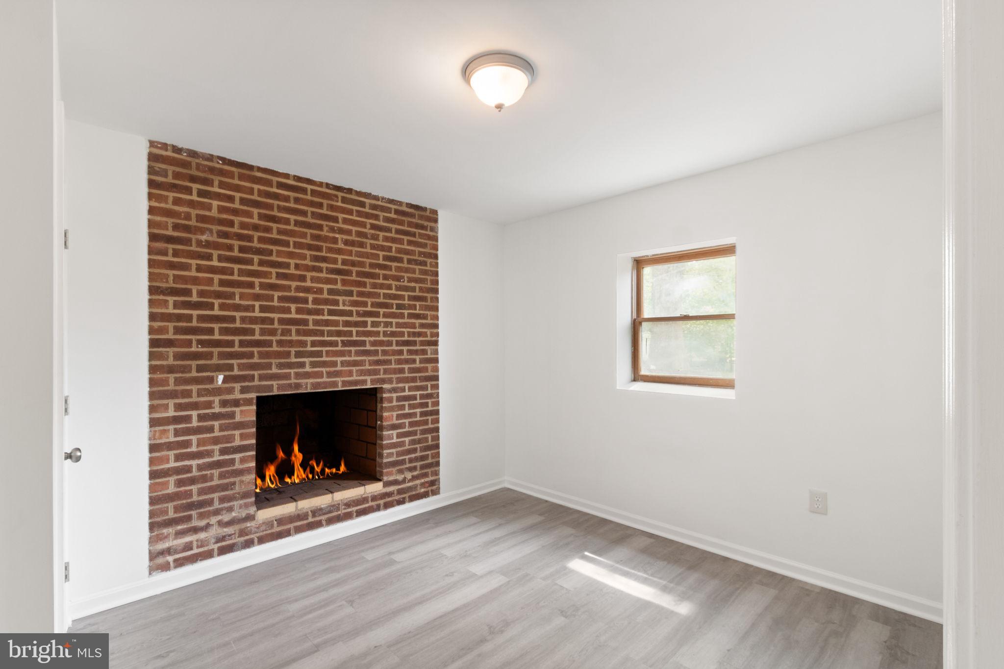 127 Oaklawn Road Stafford, VA 22554 - Photo 41 of 54 a view of an empty room with a fireplace and a window
