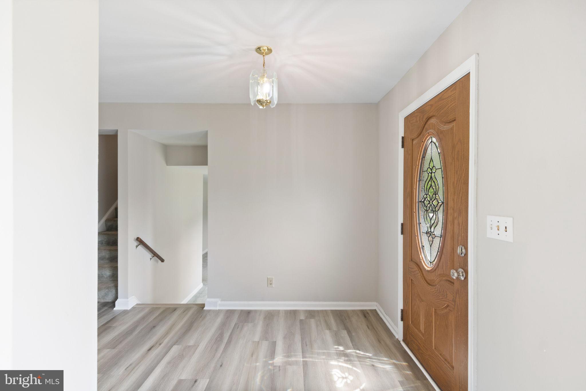 127 Oaklawn Road Stafford, VA 22554 - Photo 10 of 54 a view of an empty room with wooden floor and a window