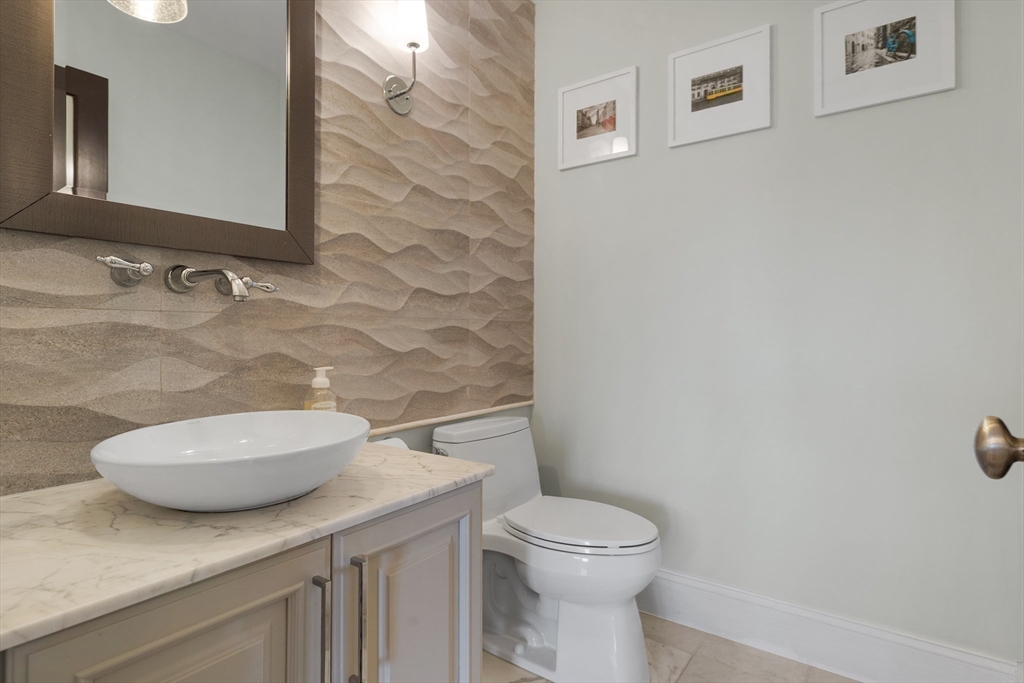 2 Thorndike Street, Unit 2 Brookline, MA 02446 - Photo 15 of 22 a bathroom with a granite countertop toilet sink and mirror