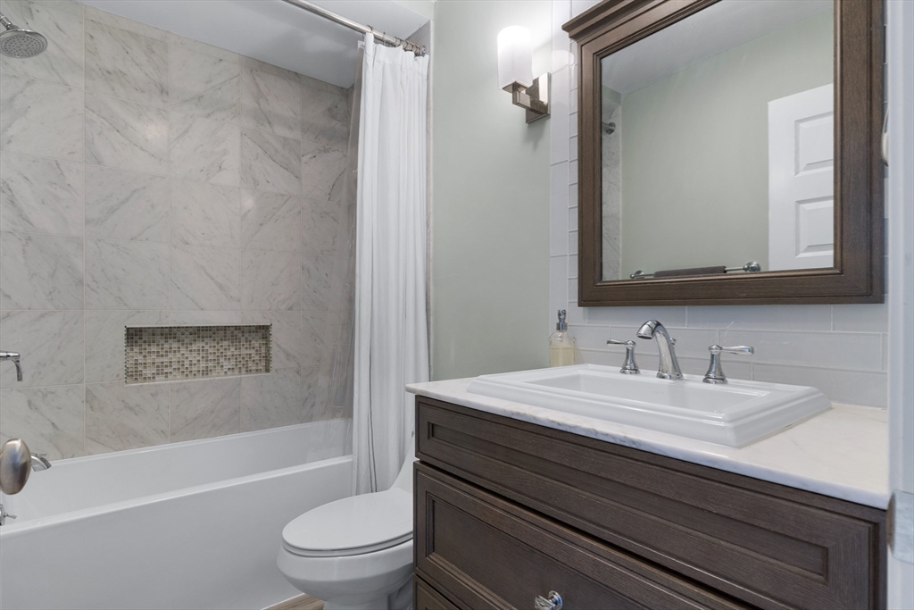 2 Thorndike Street, Unit 2 Brookline, MA 02446 - Photo 18 of 22 a bathroom with a sink a toilet and a bathtub