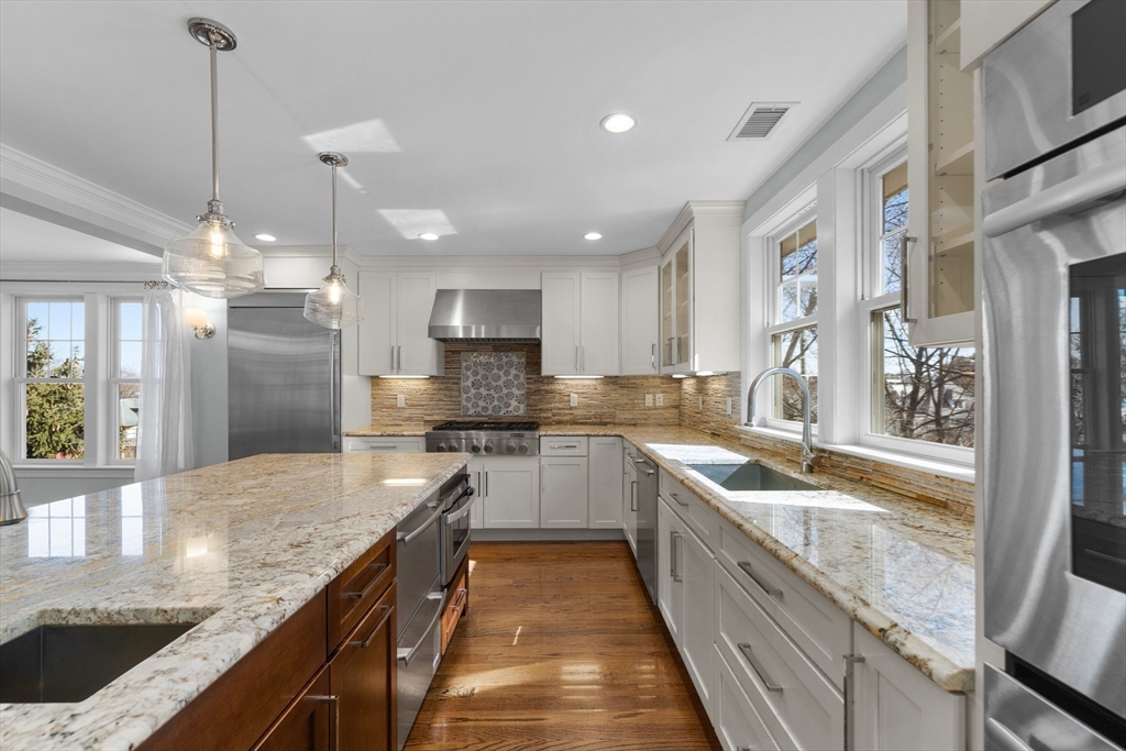 2 Thorndike Street, Unit 2 Brookline, MA 02446 - Photo 3 of 22 a large kitchen with stainless steel appliances granite countertop a sink and counter space