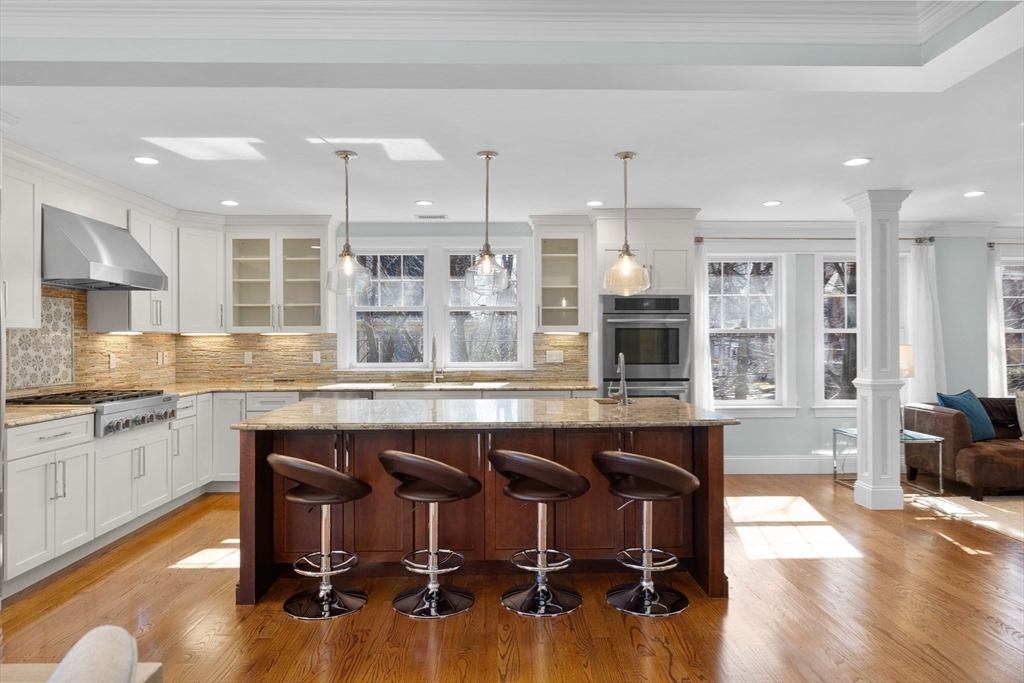 2 Thorndike Street, Unit 2 Brookline, MA 02446 - Photo 4 of 22 a kitchen with a kitchen island hardwood floor and a sink