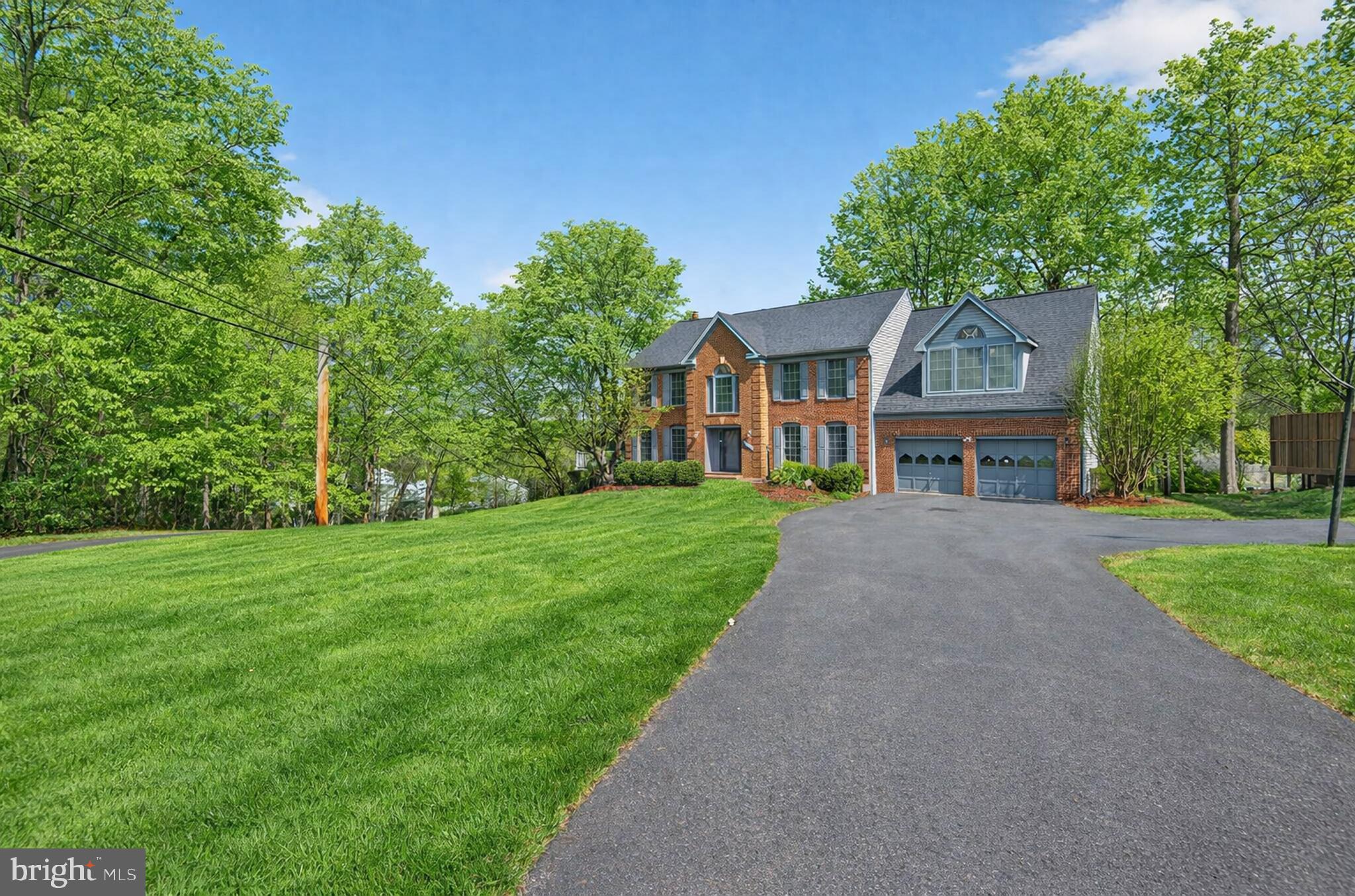 8301 Kings Ridge Court Springfield, VA 22153 - Photo 2 of 20 a front view of house with yard and green space