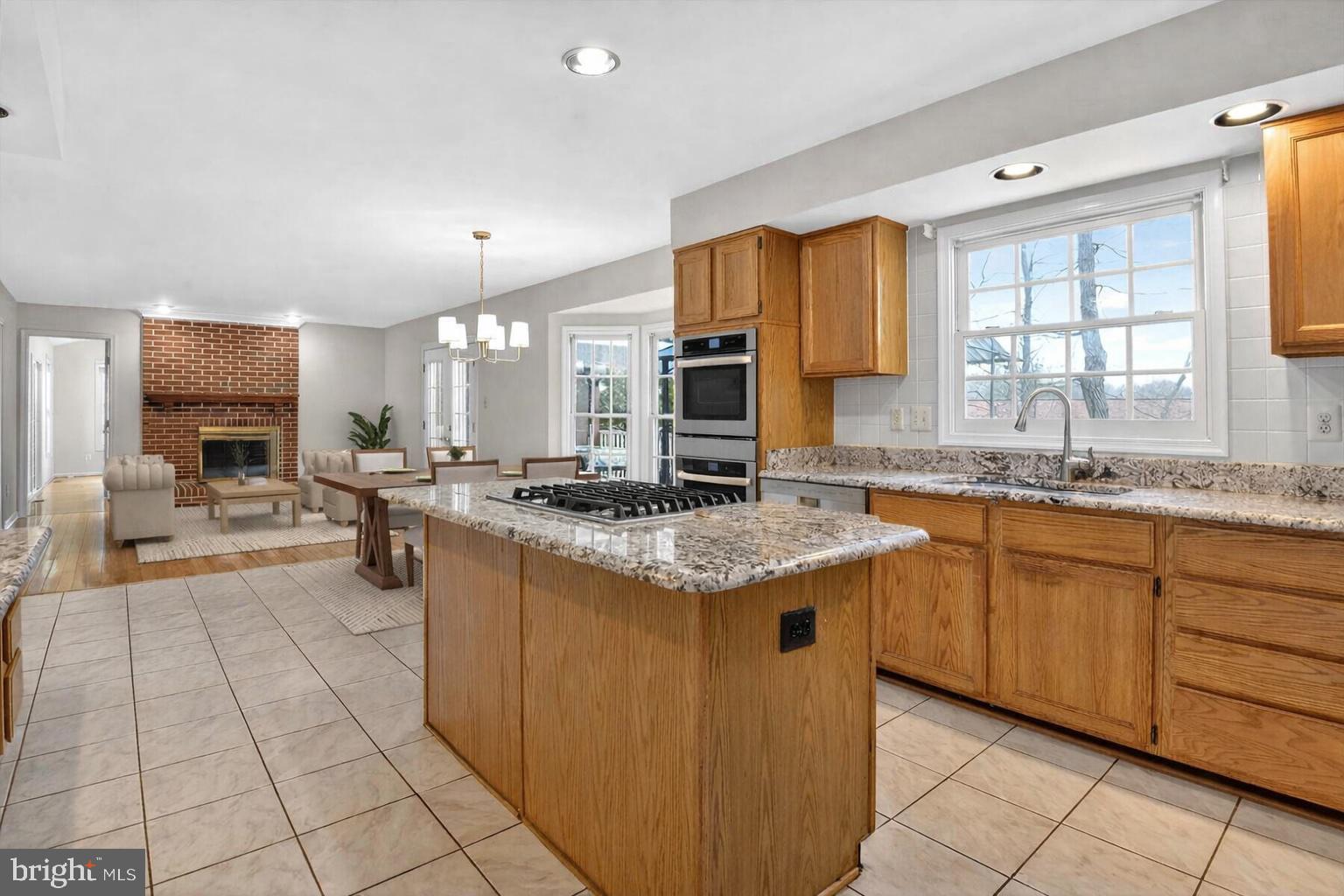 8301 Kings Ridge Court Springfield, VA 22153 - Photo 6 of 20 a kitchen with stainless steel appliances granite countertop a sink counter space cabinets and a large window