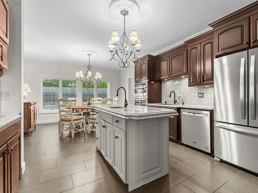 4 Quick Farm Road Westborough, MA 01581 - Photo 12 of 42 a kitchen with granite countertop a sink stainless steel appliances and dining table