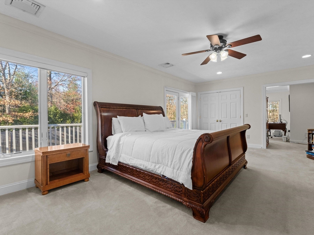 4 Quick Farm Road Westborough, MA 01581 - Photo 28 of 42 a spacious bedroom with a bed and a chandelier