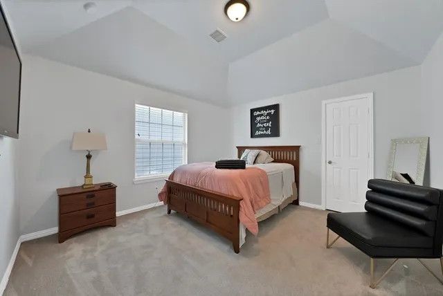 a bedroom with bed couch and window