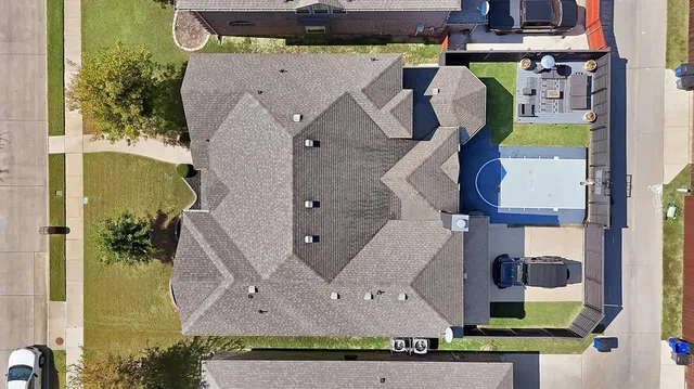 an aerial view of residential houses with outdoor space