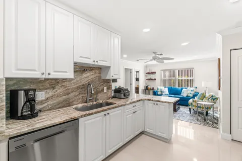 a kitchen with sink and cabinets