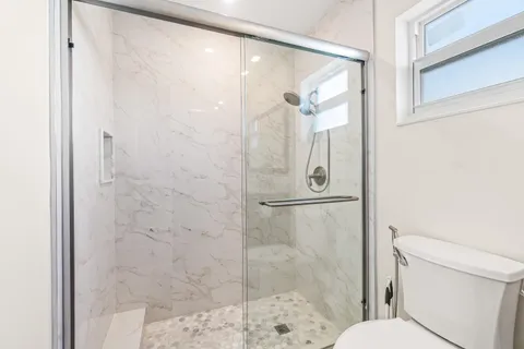 a bathroom with a shower and toilet