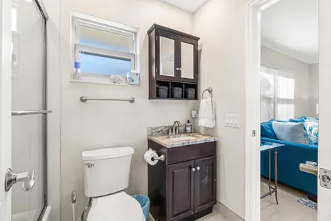 a bathroom with a toilet a sink and mirror