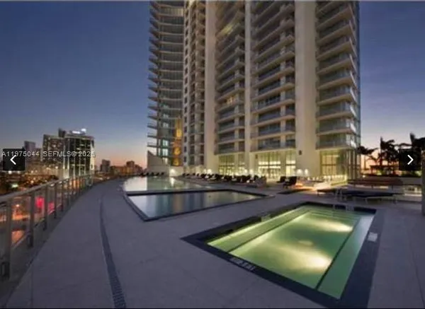 a living room with couch and a chandelier
