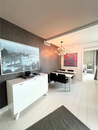 a living room with furniture a rug and a large window