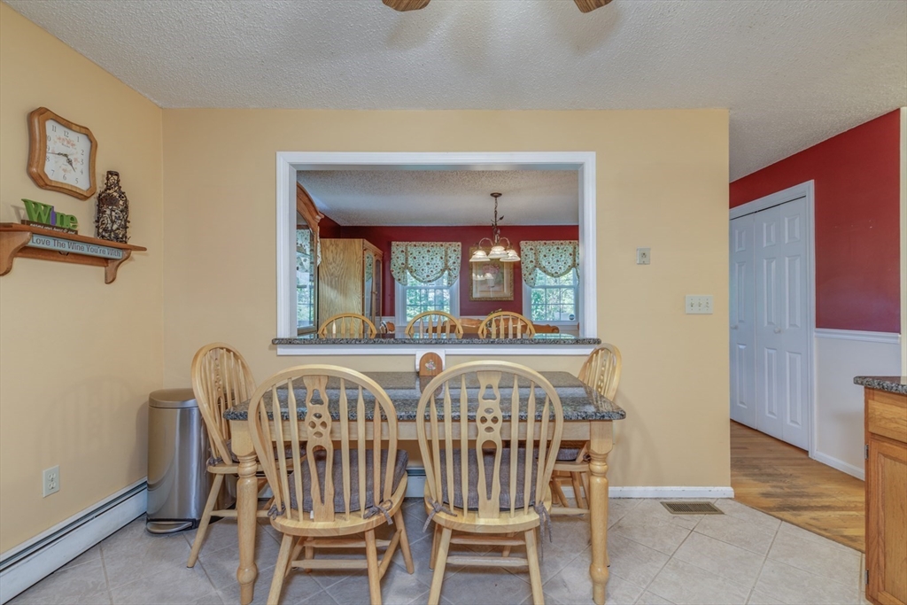 50 Kienia Road Hudson, NH 03051 - Photo 11 of 42 a view of a dining room with furniture and window