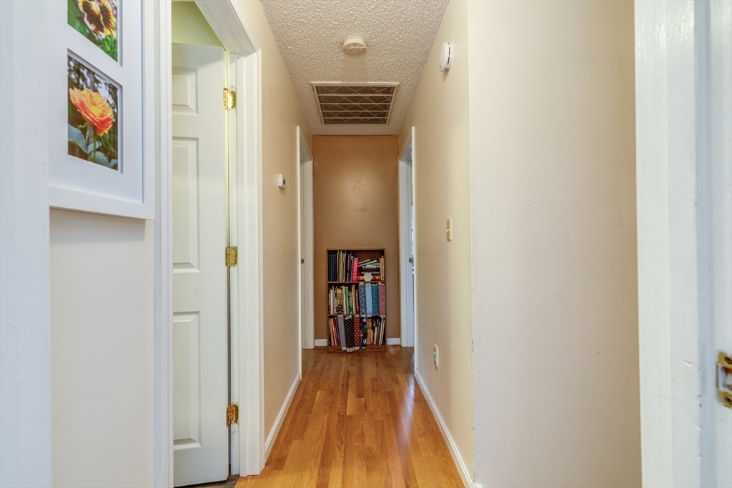 50 Kienia Road Hudson, NH 03051 - Photo 14 of 42 a view of a hallway with wooden floor and dining room