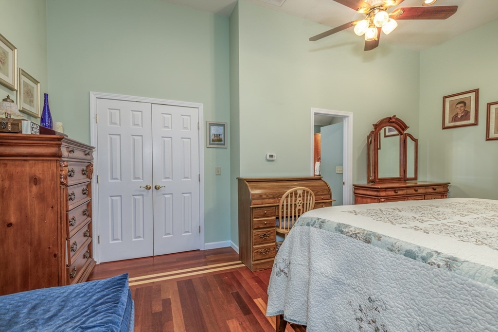 50 Kienia Road Hudson, NH 03051 - Photo 17 of 42 a bedroom with a bed and a chandelier