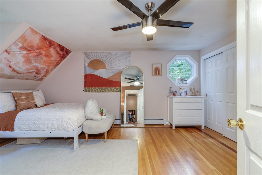 50 Kienia Road Hudson, NH 03051 - Photo 22 of 42 a spacious bedroom with a bed and a chandelier