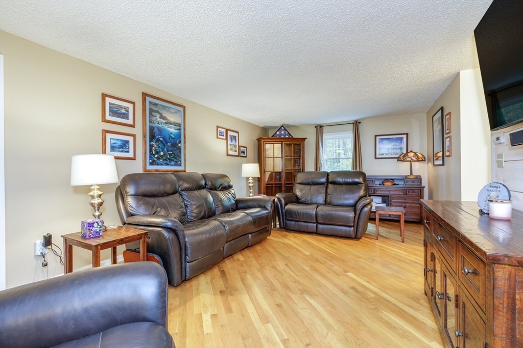 50 Kienia Road Hudson, NH 03051 - Photo 3 of 42 a living room with furniture and a flat screen tv