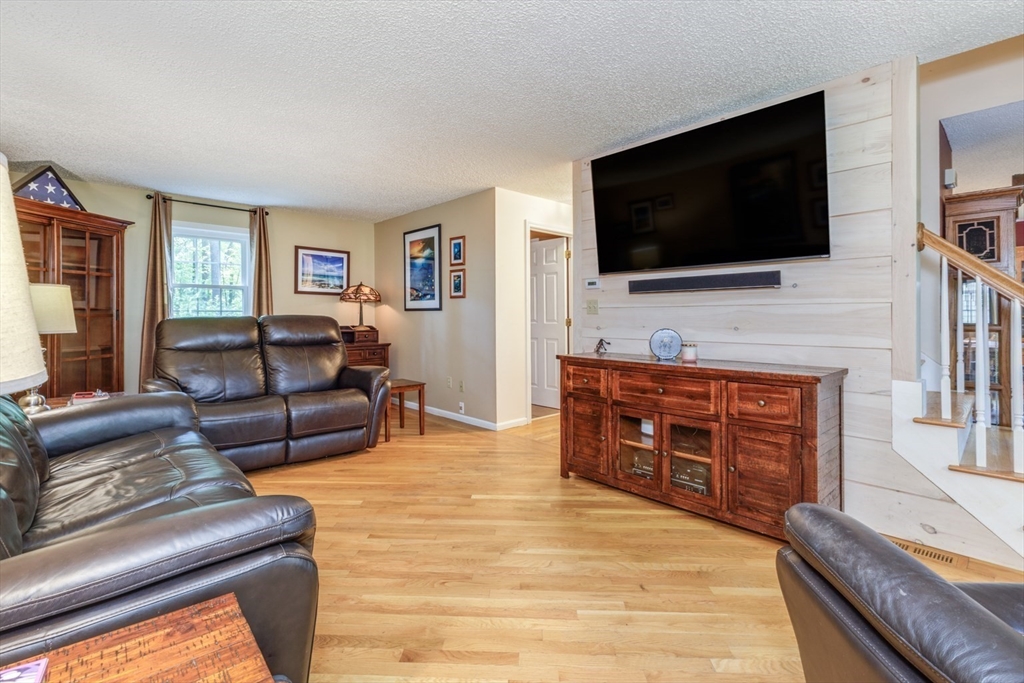 50 Kienia Road Hudson, NH 03051 - Photo 4 of 42 a living room with furniture and a flat screen tv