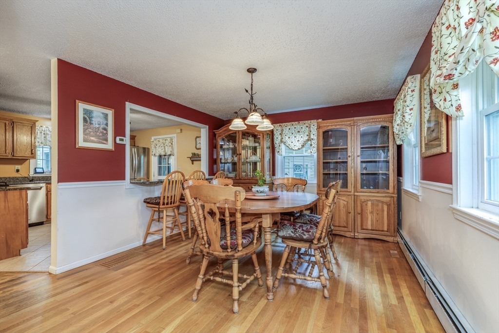 50 Kienia Road Hudson, NH 03051 - Photo 7 of 42 a view of a dining room with furniture window and wooden floor