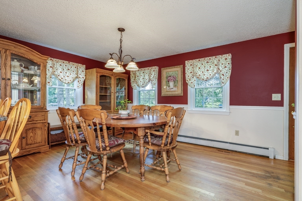 50 Kienia Road Hudson, NH 03051 - Photo 8 of 42 a view of a dining room with furniture window and wooden floor