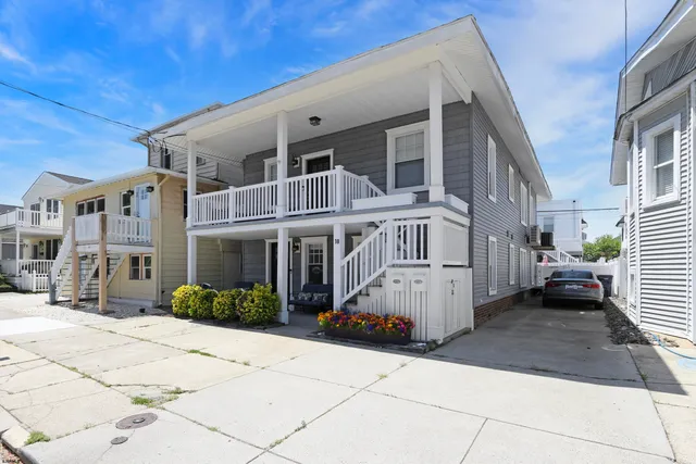 a view of a white building among the street with a building