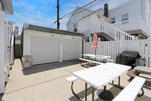 a view of a patio with table and chairs