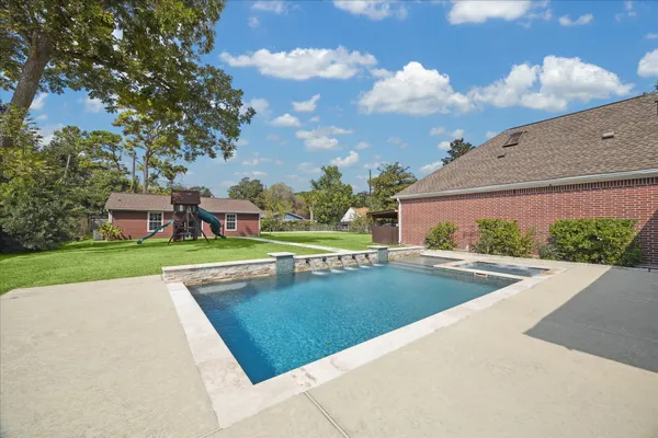 a view of a swimming pool with a yard