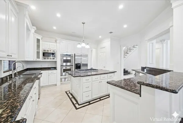 a kitchen with stainless steel appliances granite countertop a stove top oven a sink a counter space and cabinets