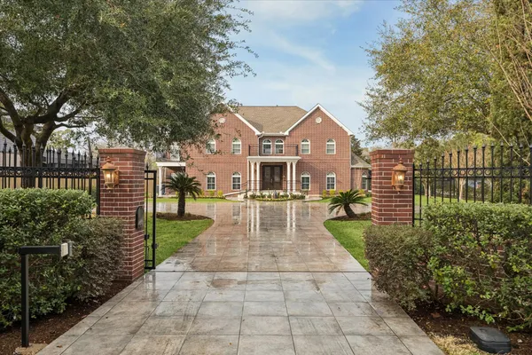 a front view of a house with a garden and plants