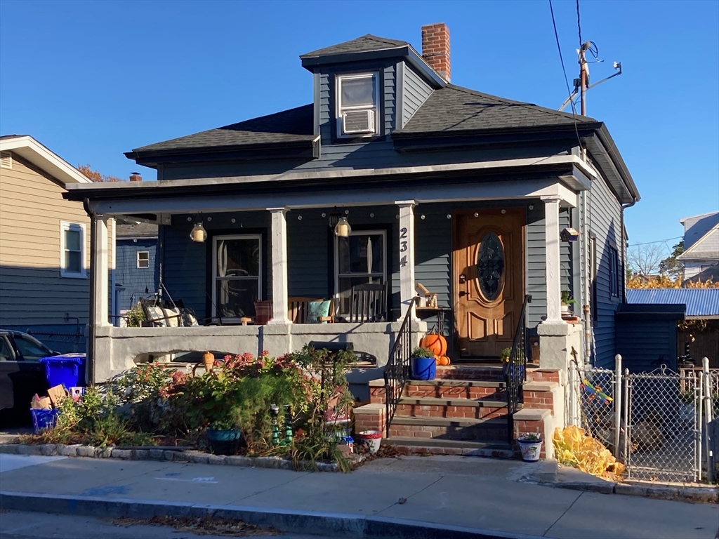 a front view of a house with outdoor seating and potted plants