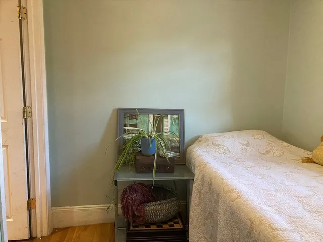 a bedroom with a bed and a mirror