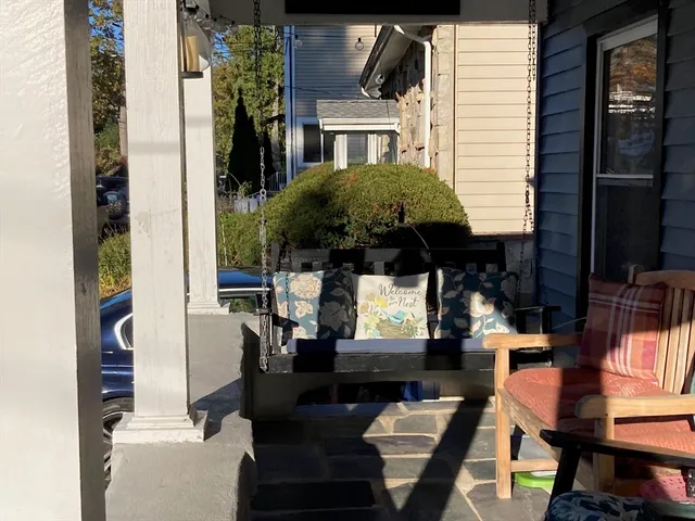 a view of a patio with table and chairs potted plants