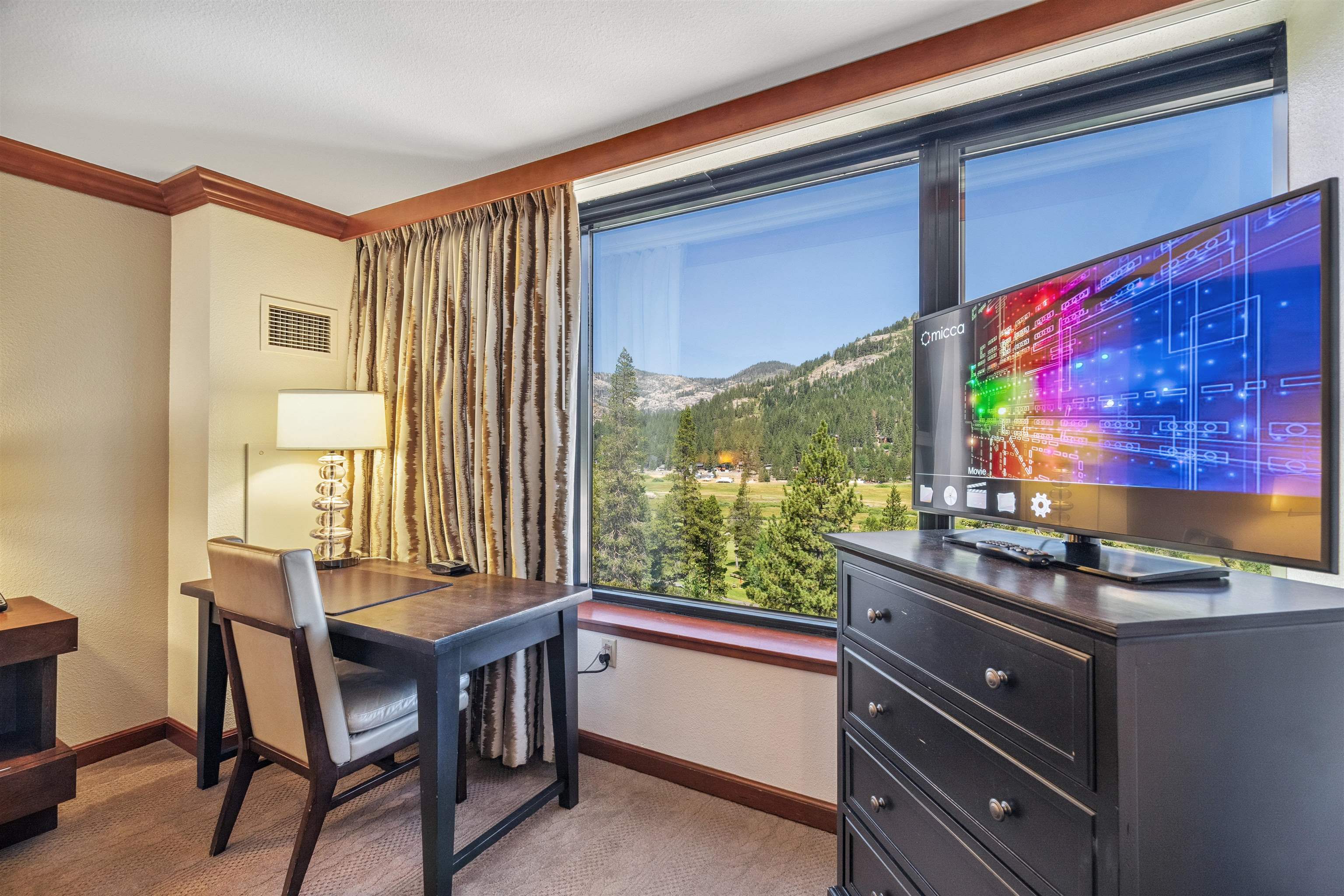 400 Resort Road, Unit 932 Olympic Valley, CA 96146 - Photo 12 of 24 a dining room with a wooden table and chairs