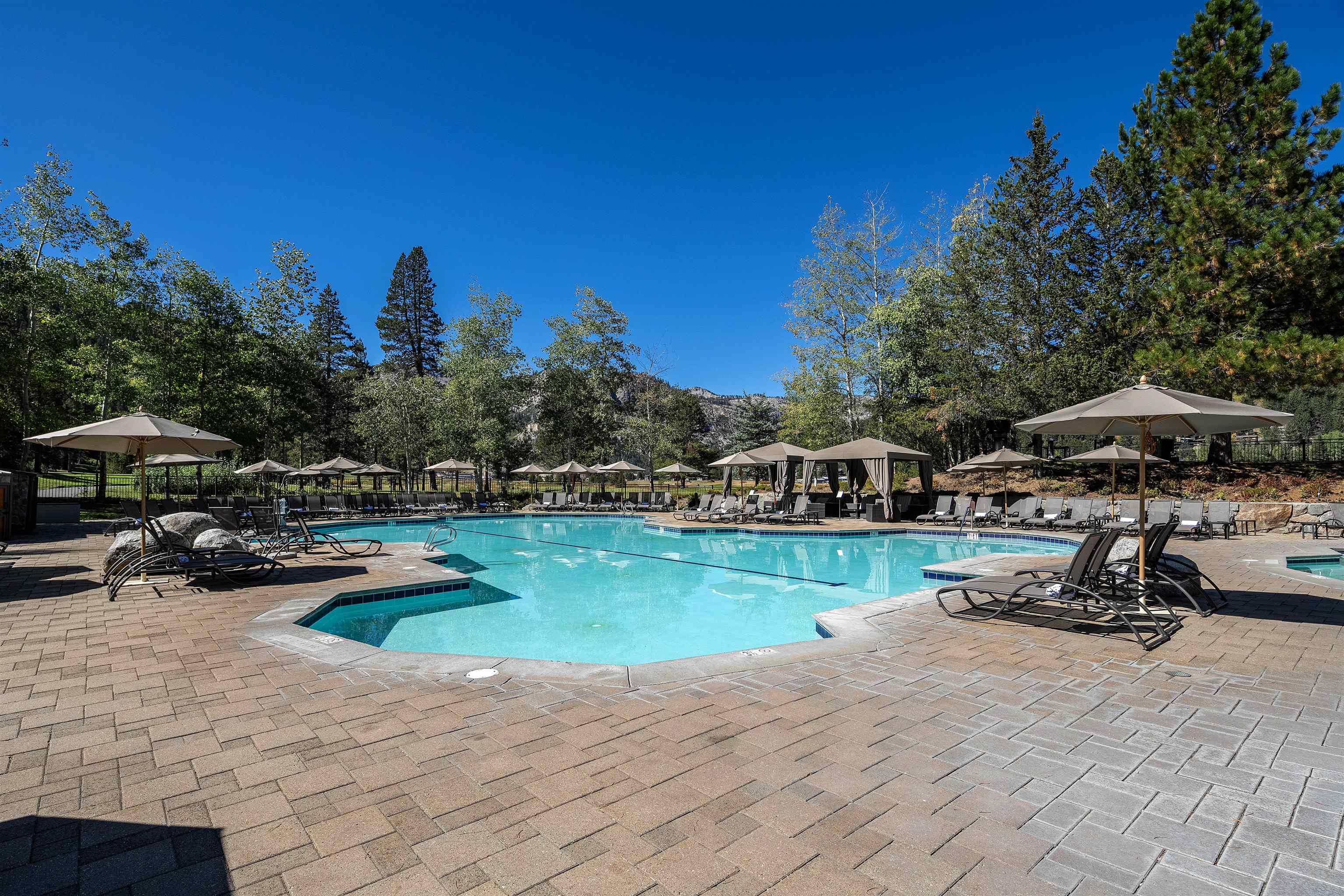 400 Resort Road, Unit 932 Olympic Valley, CA 96146 - Photo 19 of 24 a view of a lake with a table and chairs under an umbrella